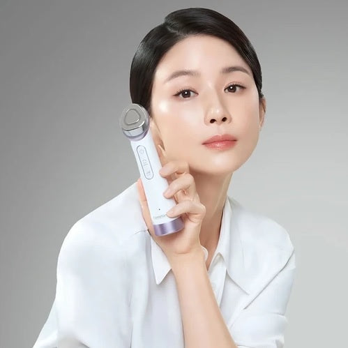 Дівчина азіатської зовнішності тримає мікрострумовий девайс для догляду за обличчям біля обличчя.