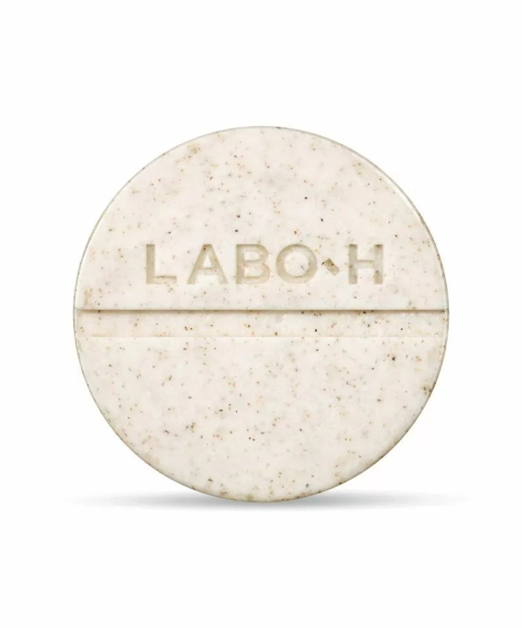 Твердий шампунь LABO-H у зручній круглій формі бежевого кольору з темними вкрапленнями, на білому фоні