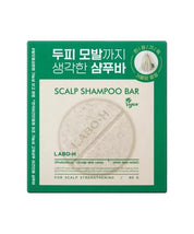 Зелено-бежева упаковка твердого шампуню LABO-H, на білому фоні