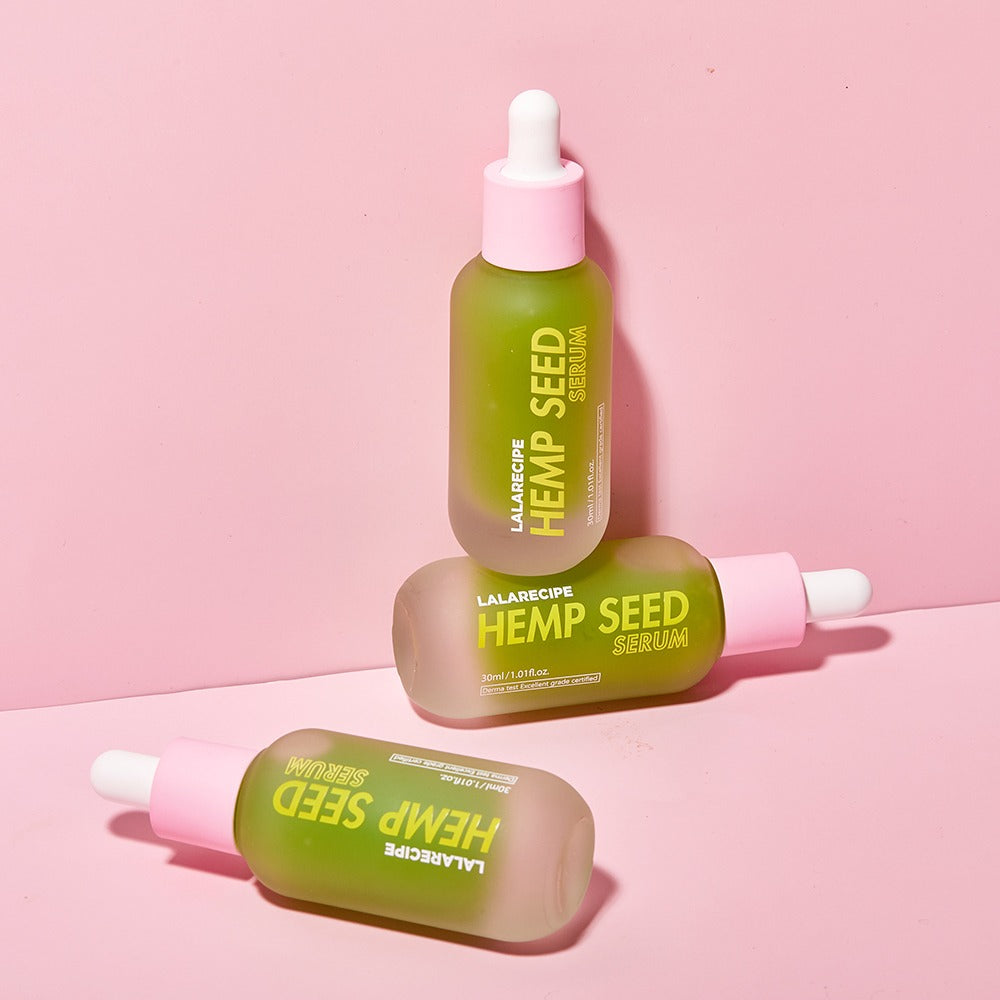 Конопляна сироватка для обличчя LALARECIPE Hemp Seed Serum у трьох флаконах на рожевому фоні