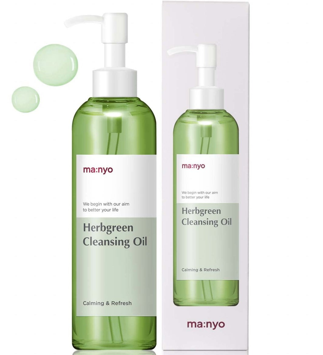 Зелена пляшечка з білою етикеткою та білим дозатором Ma:nyo Herb Cleansing Oil поряд з коробкою від цього засобу стоять на білому фоні, біля дозатора — зелені кульки.