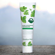 На кам'яній поверхні стоїть тюбик зубної пасти NARD Whitening Toothpaste.