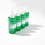 Чотири ампули сироватки Nine Less A-Control 10% Azelaic Acid Serum стоять у ряд на білій поверхні.