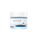 Прозора баночка з етикеткою та білою кришкою крему Round Lab Juice Moisturizing Cream стоїть на білому фоні.