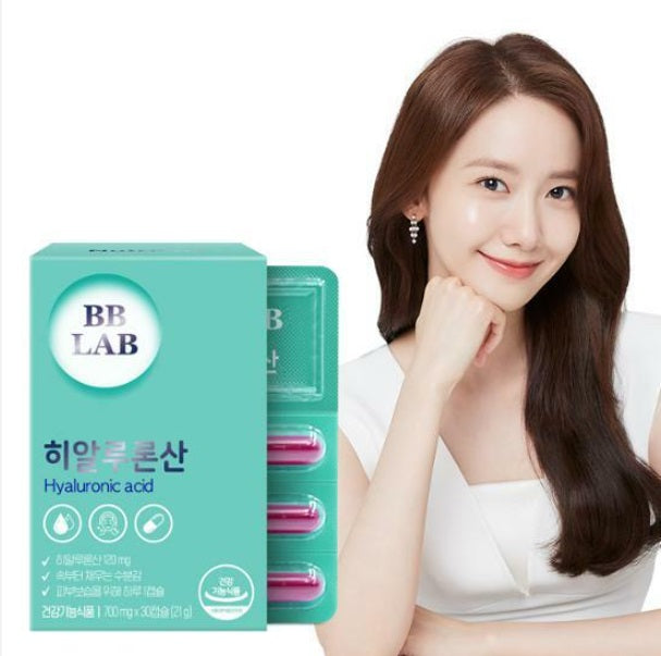 Коробка з пластинкою колагену BB Lab Hyaluronic Acid на фоні дівчина азіатської зовнішності посміхається.